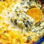 Serving a creamy hot spinach and artichoke dip in a baking dish